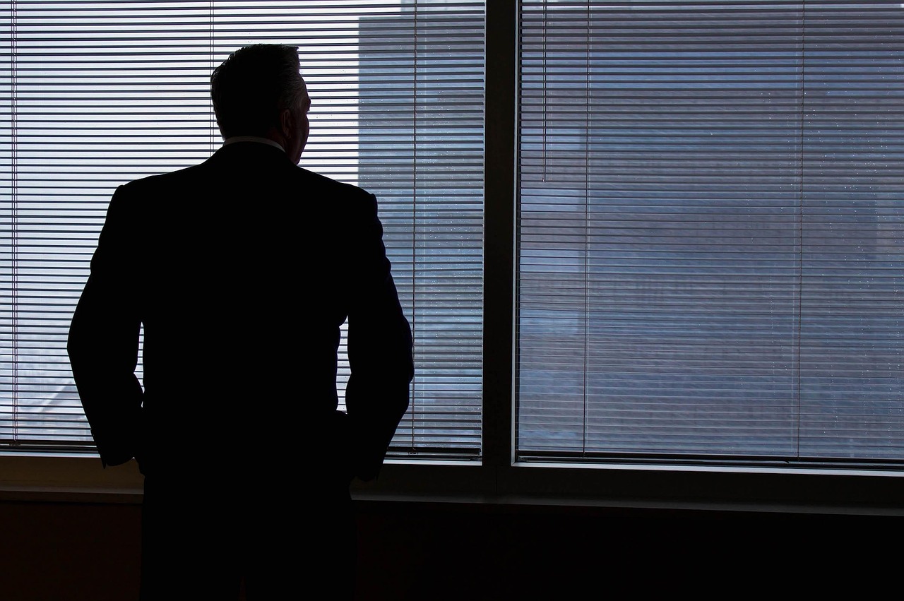 Businessman looking at window planning next steps